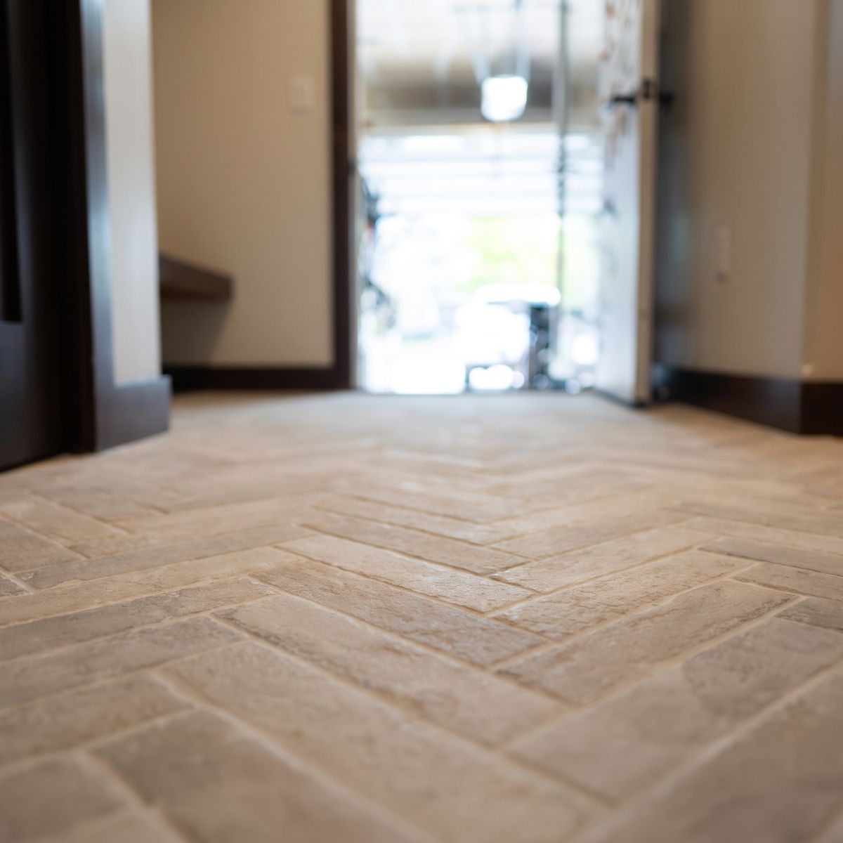Herringbone brick-look tile floor installed in Coralville, Iowa